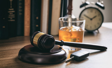 gavel, car keys, and alcohol glass