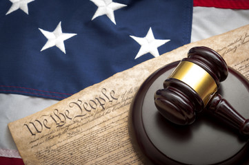 gavel and constitution on american flag